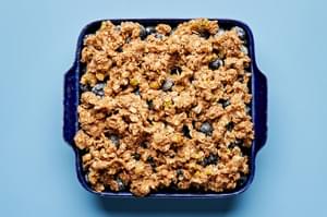 Brown Butter Blueberry Crumble with Pistachios in a baking dish