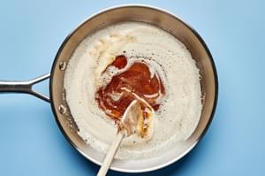 flour, oats, brown sugar and salt being stirred into browned butter in a skillet