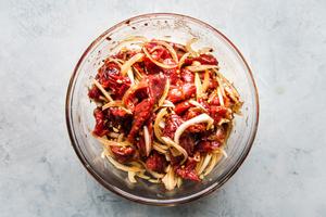 thinly sliced steak, thinly sliced onions, garlic and brown sugar mixed together in a bowl