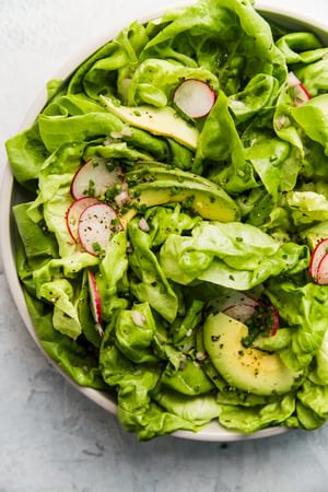simple butter lettuce salad with homemade honey mustard vinaigrette in a bowl