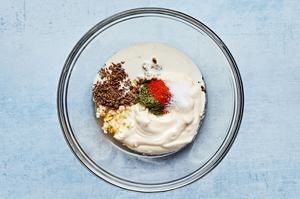 mayonnaise, vinegar, mustard, caraway seeds, dill, paprika, sugar, and garlic in a glass bowl