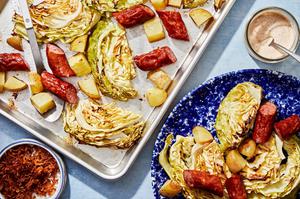 cabbage and sausage sheet pan dinner being scooped onto plates
