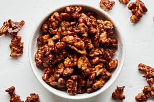 a bowl of homemade candied walnuts made with brown sugar, butter, salt and cayenne