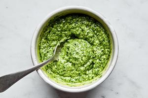 pesto and mayonnaise stirred together in a bowl