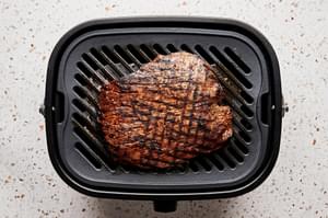 carne asada being cooked on an electric grill