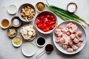ingredients for cashew chicken laid out on a counter. Hoisin sauce, soy sauce, water chestnuts, red bell pepper, garlic