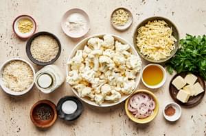 Cauliflower, Parmesan, Gruyère, olive oil, butter, breadcrumbs, shallot, garlic, flour, milk and spices in prep bowls