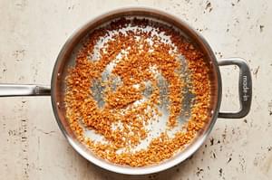 panko breadcrumbs being toasted in butter in a skillet