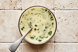 tarragon being stirred into homemade pear vinaigrette