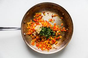 minced Onion, Bell peppers, garlic and cilantro in olive oil in a skillet