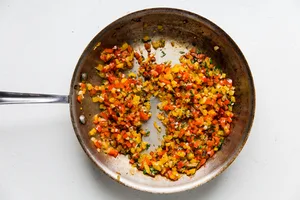 cooked Onion, Bell peppers, Garlic and cilantro cooked in a skillet