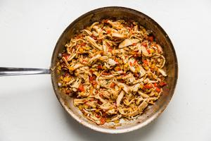 Onion, Bell peppers, Garlic and cilantro chicken and tomatoes sautéed in a pan