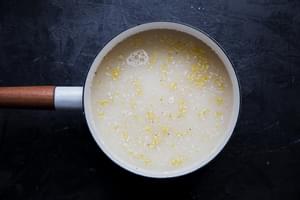 chicken stock and polenta in a pot