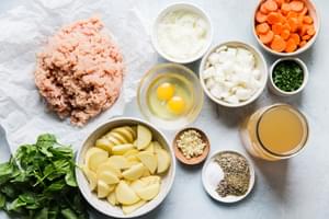 ground chicken, onion, potatoes, carrots, spinach, spices, stock, parsley and spices in prep bowls