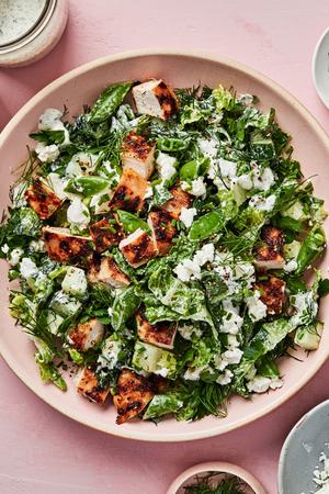 Chicken Chop Salad with Chèvre Ranch sprinkled with pepper, dill and chives in a serving bowl