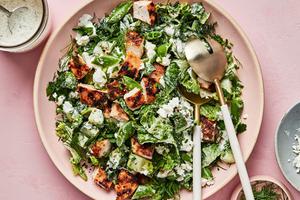 Chicken Chop Salad with Chèvre Ranch sprinkled with pepper, dill and chives in a serving bowl with salad servers