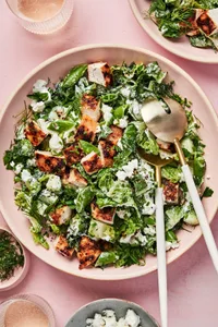 Chicken Chop Salad with Chèvre Ranch sprinkled with pepper, dill and chives in a serving bowl with serving spoons