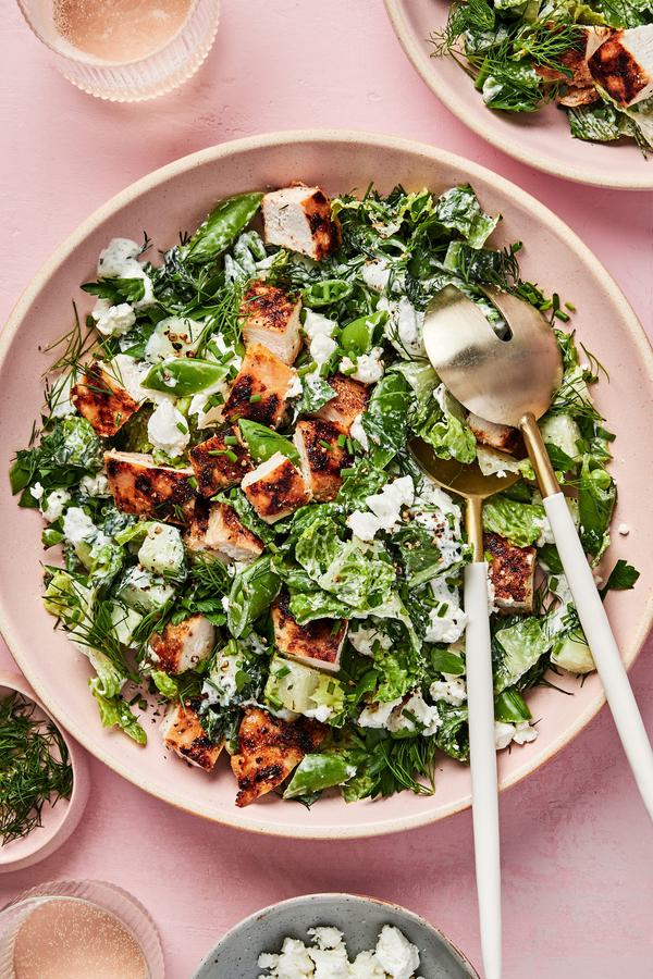 Chicken Chop Salad with Chèvre Ranch sprinkled with pepper, dill and chives in a serving bowl with serving spoons