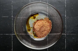 olive oil, lime juice and homemade taco seasoning being combined in a bowl