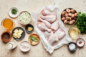 skin on chicken thighs and legs, spices, mushrooms, butter, onion, flour, wine, stock, cream and parsley in prep bowls