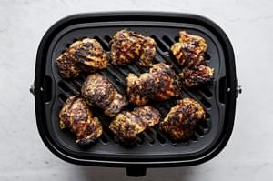 Chicken gyro meat grilling on an indoor grill.