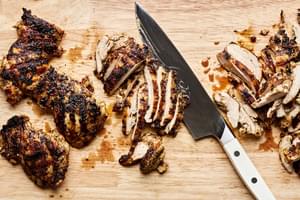 Chicken gyro meat being slice on a cutting board