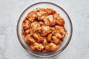 raw chicken tossed with lemon juice, olive oil, dill, oregano, basil, paprika, onion powder, garlic powder, salt, and pepper