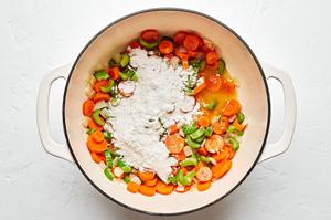 flour added to a pot with carrots, celery, and onion that have been cooked in butter