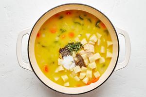 potatoes, spices, stock, butter, flour, carrots, celery, and onion cooking in a large pot