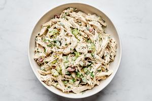 chicken salad in a bowl made with mayo, dijon, spices, celery, pecans, parsley, lemon zest & lemon juice