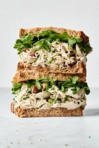 homemade chicken salad  sandwich with celery and pecans with arugula