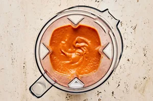 tinga sauce in a blender made with tomatoes, chipotle peppers, onions, garlic and spices
