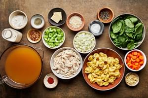 butter, flour, spices, carrots, celery, spinach, tortellini, chicken, broth, cream and Parmesan in prep bowls
