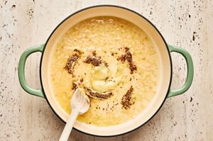 Creamy mustard sauce cooking in a skillet to be used as a finishing touch for baked chicken