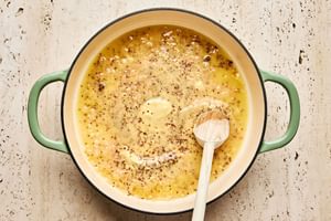 Creamy mustard sauce cooking in a skillet to be used as a finishing touch for baked chicken