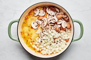 mushrooms, onions and garlic cooking in butter in a skillet
