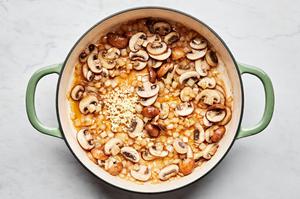 mushroom, onion and garlic cooking in butter in a skillet