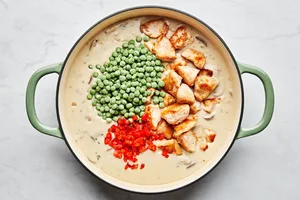 peas, chicken and pimentos added to a skillet with cream sauce