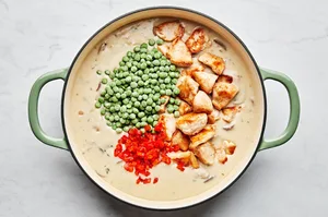 peas, chicken and pimentos added to a skillet with cream sauce
