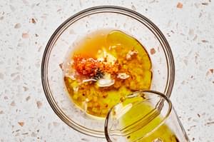olive oil, vinegar, clementine zest, clementine juice, honey, Dijon, shallots, salt, & pepper being combined in a glass bowl