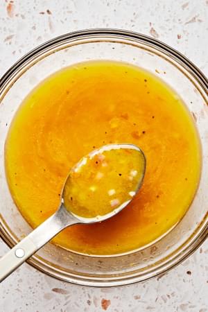 salad dressing made with olive oil, vinegar, clementine zest, clementine juice, honey, Dijon, shallots, salt, & pepper