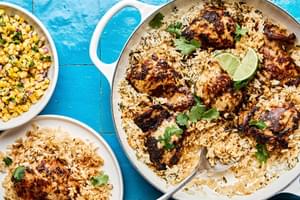 A Cilantro Lime Chicken & Rice Skillet served with corn salad and a creamy lime sauce