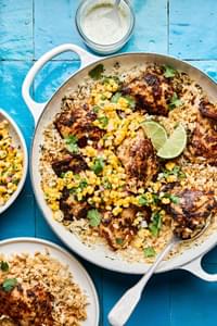 A Cilantro Lime Chicken & Rice Skillet served with corn salad and a creamy lime sauce