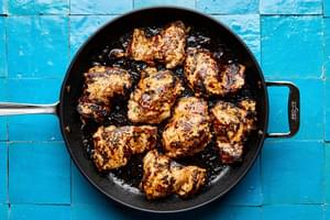 chicken thighs marinated in olive oil, garlic, honey, lime zest & juice, cilantro, chili powder, salt & pepper in a skillet