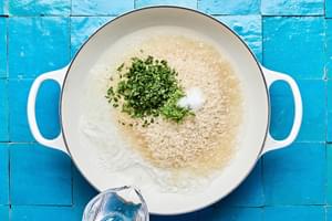 rice, vegetable oil, salt, lime zest, lime juice, cilantro, and  water cooking in a skillet