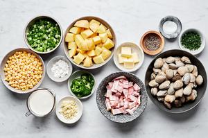 clams, bacon, scallions, potatoes, corn, garlic, jalapeño, heavy cream, and spices in prep bowls for clam chowder