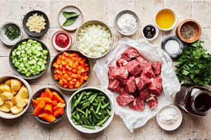 chuck roast, green beans, carrots, potatoes, celery, onion, garlic, parsley, beef stock, flour and spices in prep bowls