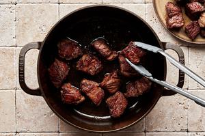chuck roast cut in to 2 inch pieces tossed with salt, pepper and flour being browned in olive oil in a pot