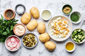 potatoes, chives, parsley, cucumbers, pickles, eggs, radishes, mayo, olive oil, ground mustard & pickle juice in prep bowls