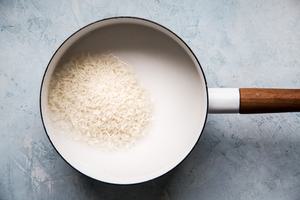 coconut milk, water, jasmine rice, salt and sugar cooking in a sauce pan